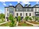 Beautiful view of a new construction white brick townhome with professional landscaping at 445 Breccia Run, Mcdonough, GA 30253