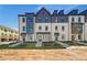 Attractive townhome showcases classic brickwork, multiple windows, and professionally manicured landscaping at 445 Breccia Run, Mcdonough, GA 30253
