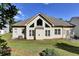 Back of house showing well-kept lawn, patio set, and large windows at 6772 Blantyre Boulevard Blvd, Stone Mountain, GA 30087