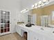 Bright bathroom offers dual sinks, large mirrors, and a separate shower and tub at 6772 Blantyre Boulevard Blvd, Stone Mountain, GA 30087