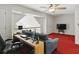 Bonus room with desk area, comfortable blue sofa, and a ceiling fan, perfect for relaxation and work at 6772 Blantyre Boulevard Blvd, Stone Mountain, GA 30087