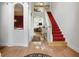 Grand foyer with hardwood floors, staircase with red carpet, and elegant architectural details at 6772 Blantyre Boulevard Blvd, Stone Mountain, GA 30087