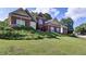 Attractive two-story home with manicured lawn, lush shrubbery, and traditional architecture at 6772 Blantyre Boulevard Blvd, Stone Mountain, GA 30087