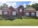 Charming brick home with a well-manicured lawn and lush green shrubbery enhancing its curb appeal at 6772 Blantyre Boulevard Blvd, Stone Mountain, GA 30087