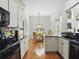 Bright kitchen with white cabinets, dark countertops, and stainless steel appliances at 6772 Blantyre Boulevard Blvd, Stone Mountain, GA 30087