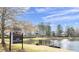 Scenic lake view at Deer Creek with a sign, fountain, and inviting picnic area for residents to enjoy at 6772 Blantyre Boulevard Blvd, Stone Mountain, GA 30087