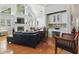 Bright living room with vaulted ceiling and fireplace, showing leather sofa and stylish wood chair at 6772 Blantyre Boulevard Blvd, Stone Mountain, GA 30087