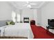 Bright main bedroom with a ceiling fan, fireplace, red carpet, and plenty of space at 6772 Blantyre Boulevard Blvd, Stone Mountain, GA 30087
