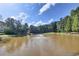 Scenic view of the pond with a fountain, surrounded by trees, adding charm to the community at 6772 Blantyre Boulevard Blvd, Stone Mountain, GA 30087