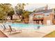 Community pool with ample seating, deck, lounge chairs, and surrounding foliage at 6772 Blantyre Boulevard Blvd, Stone Mountain, GA 30087