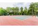 Well-maintained tennis court surrounded by lush trees, providing a serene and private playing environment at 6772 Blantyre Boulevard Blvd, Stone Mountain, GA 30087
