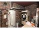 Basement area includes a water heater and dryer, with exposed brick walls and assorted items nearby at 819 Durant Ne # 819-6, Atlanta, GA 30308