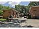 Angle view of Palisades Park condos with brick exteriors, landscaping, and a paved driveway on a partly cloudy day at 819 Durant Ne # 819-6, Atlanta, GA 30308