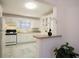 Charming kitchen with white cabinets, breakfast bar, and a view into the dining area at 819 Durant Ne # 819-6, Atlanta, GA 30308