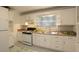 Bright kitchen with white cabinets, stainless steel sink, and patterned backsplash at 819 Durant Ne # 819-6, Atlanta, GA 30308