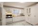 Bright kitchen with white cabinets, stainless steel sink, and patterned backsplash at 819 Durant Ne # 819-6, Atlanta, GA 30308