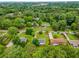 A high aerial view of a house surrounded by mature trees in a residential neighborhood at 1055 Delmont Ter, Roswell, GA 30075