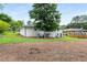 Spacious backyard featuring mature trees and a white painted brick home at 1055 Delmont Ter, Roswell, GA 30075