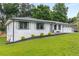 Charming home featuring a well-manicured lawn and an attached two-car garage at 1055 Delmont Ter, Roswell, GA 30075