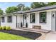 Quaint home with a white painted brick, manicured garden beds, and bench at 1055 Delmont Ter, Roswell, GA 30075