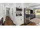 Kitchen area with stainless steel refrigerator, microwave, white cabinets, and hardwood floors at 1055 Delmont Ter, Roswell, GA 30075