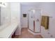 Bright bathroom featuring a glass-enclosed shower and a long vanity with countertop space at 2191 Rockbridge Rd # 103, Stone Mountain, GA 30087