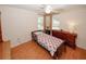 Cozy bedroom with warm wood floors, ceiling fan, and natural light from two windows at 2191 Rockbridge Rd # 103, Stone Mountain, GA 30087