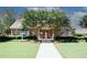 Beautiful community clubhouse entrance with stone exterior, manicured landscaping, and a walkway at 2191 Rockbridge Rd # 103, Stone Mountain, GA 30087