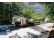 Community entrance with a tree-lined street and manicured landscaping at 2191 Rockbridge Rd # 103, Stone Mountain, GA 30087