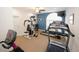 Well-equipped fitness room with treadmills, a weight machine, and wall-mounted television at 2191 Rockbridge Rd # 103, Stone Mountain, GA 30087