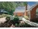 Brick home featuring manicured landscaping, a chimney, and a decorative front door wreath at 2191 Rockbridge Rd # 103, Stone Mountain, GA 30087