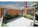 Brick home featuring a chimney, front yard landscaping, and a decorative front door wreath at 2191 Rockbridge Rd # 103, Stone Mountain, GA 30087
