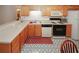 Functional kitchen area featuring oak cabinets, modern appliances, and patterned flooring at 2191 Rockbridge Rd # 103, Stone Mountain, GA 30087