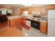 Bright kitchen and dining area with oak cabinets and modern appliances at 2191 Rockbridge Rd # 103, Stone Mountain, GA 30087