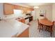 Well-lit kitchen with oak cabinets, modern appliances, and a cozy dining area at 2191 Rockbridge Rd # 103, Stone Mountain, GA 30087