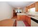 View of eat-in kitchen leading into living space featuring oak cabinets and modern appliances at 2191 Rockbridge Rd # 103, Stone Mountain, GA 30087