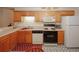 Bright kitchen features wood cabinets, black appliances, and durable countertops at 2191 Rockbridge Rd # 103, Stone Mountain, GA 30087
