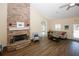 Inviting living room featuring a stone fireplace, wood flooring and neutral color palette at 2191 Rockbridge Rd # 103, Stone Mountain, GA 30087