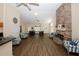 Open concept living room with a stone fireplace, wood floor, seating, and dining area at 2191 Rockbridge Rd # 103, Stone Mountain, GA 30087