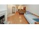 Open concept living room with hardwood floors, a fireplace, and access to the kitchen at 2191 Rockbridge Rd # 103, Stone Mountain, GA 30087