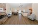 Spacious living room with hardwood floors, fireplace, ample seating, and a kitchen area at 2191 Rockbridge Rd # 103, Stone Mountain, GA 30087