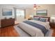 Nicely appointed main bedroom with a neutral color palette, wood floors, and contemporary decor at 2191 Rockbridge Rd # 103, Stone Mountain, GA 30087