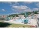 Community pool area with lounge chairs, tables, umbrellas, and a white picket fence at 2191 Rockbridge Rd # 103, Stone Mountain, GA 30087
