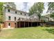 View of the backyard showcasing the deck, patio and large grassy yard with mature trees at 3707 Dunwoody Club Dr, Atlanta, GA 30350