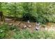 Backyard view showing a stone fire pit area surrounded by mature trees and a hammock at 3707 Dunwoody Club Dr, Atlanta, GA 30350