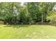Landscaped backyard with a privacy fence and mature trees provides a serene and private outdoor space at 3707 Dunwoody Club Dr, Atlanta, GA 30350