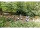 A backyard patio with a fire pit and a hammock hanging between the trees creates a serene outdoor living space at 3707 Dunwoody Club Dr, Atlanta, GA 30350