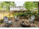 Backyard with a stone firepit area and mature trees, creating a perfect outdoor retreat at 3707 Dunwoody Club Dr, Atlanta, GA 30350