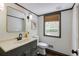 Charming powder room with decorative mirror, dark vanity, and wood-look floor at 3707 Dunwoody Club Dr, Atlanta, GA 30350