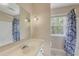 Bathroom featuring a white vanity, a framed mirror, decorative sconces, and shower with patterned curtain at 3707 Dunwoody Club Dr, Atlanta, GA 30350